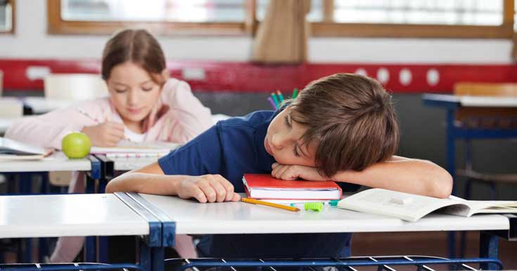 little-boy-sleeping-on-desk-girl